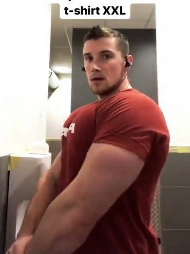 Giant muscle bull Joffrey Vassaux in orange shirt flexing giant muscles