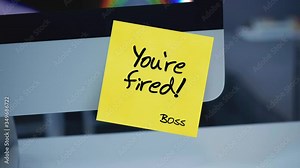 Sticky notes. You're fired. The inscription on the sticker on the monitor. Financial crisis, business crash. Dismissal during quarantine. Unemployment. Message. A message for an employee.
