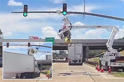 Wild video shows utility worker dangle over busy street after 18-wheeler smashes into him