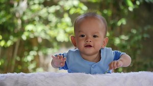 Download Slow motion Baby laying on bed and laughing happy time for free