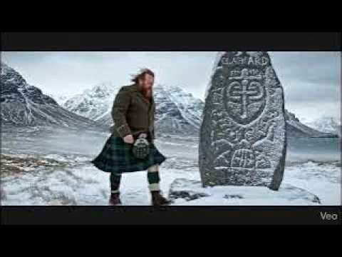 Scotsman Walking Wearing Kilt By Clach Ard Stone On Winter History Visit To Isle Of Skye Scotland