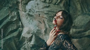 fashion woman posing with snake, portrait close-up Gothic fantasy woman dark queen. Girl holds in hands plays with aspred snake sinaloa. Lady vampire, black dress. Royal milk snake crawls on skin face