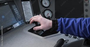 Locomotive engineer hands on controls. Train driver. Train drive, a professional driver of a locomotive or cab of a train