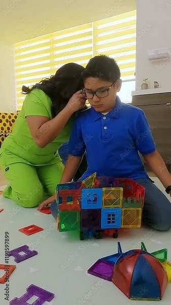 Pediatrician examining a child's ear with a stethoscope. Mexican pediatrician examining a child's ear