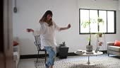 Young woman dancing at home