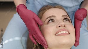 Orthodontic procedure, Jaw evaluation, Woman examination. Doctor is physically examining jaw joints female patient in his capacity as orthodontist-gnathologist.