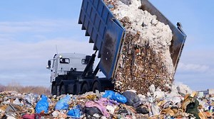 clip-24819701-4k-truck-offloading-waste-into-huge-landfill