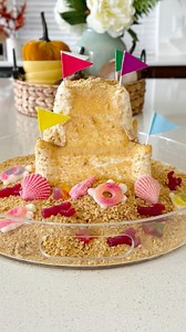 Ice Cream Sand Castle🏰🐚Instructions:•Grab your favorite sand castle mold and fill it with vanilla ice cream. * Put it in the freezer overnight so it can fully solidify. * Take out of the freezer and place onto a platter. * I used a blow dryer to slightly defrost the outside edges so it would pop out of the mold without being too melded. * I crushed up graham crackers and sprinkled them all over to look like sand. * Decorate with white chocolate seashells and beach gummy candies!#icecrean #icec