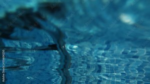 Railings above and stairs under water in swimming pool