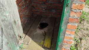 Camera moves inside an old village toilet