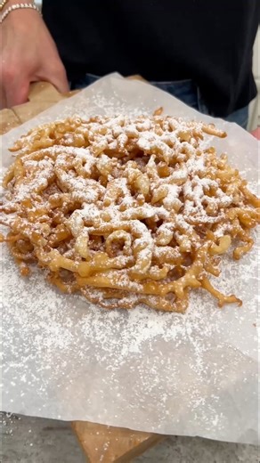 Funnel Cakes! 🎡🎪🎟️ Light and crispy deep fried batter gets a dusting of powdered sugar for a scrumptious treat that cannot be beat! It takes about 5 minutes to stir together the batter and then about 5 minutes per funnel cake to fry them into crispy sweet perfection. Seriously, so easy! | The Bakermama
