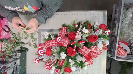 Who's ready to bring some peppermint magic to your holiday table? In this tutorial, Coach Juli e iscreating a long red white Christmas table arrangement that’s packed with festive ribbon, candy-inspired accents, and cheerful blooms. Perfect for making your holiday gatherings extra merry bright as your loved ones gather around your table. | Southern Charm Wreaths