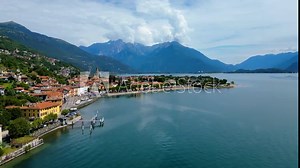 An aerial view of Domaso, a beautiful village nestled on the shores of Lake Como, Italy, captured by a drone. This charming destination is known for its picturesque lakeside scenery, quaint streets