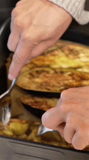 clip-4001535111-person-cooking-food-pan-fork-mix-stuffed