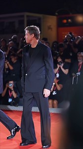 The traditional shirt-and-tie look is seemingly dead on the menswear red carpet. At the Wolfs premiere, Brad Pitt wore a custom Louis Vuitton look which comprised of a sheer T-shirt, 80s-style flared trousers, and a single-breasted blazer with a statement-making pearl button. | British GQ
