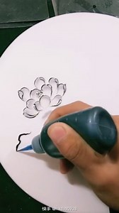 The art of painting black ink lotus flowers on white porcelain plate