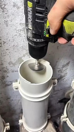 cordless power drill equipped with a specialized internal PVC pipe cutter attachment