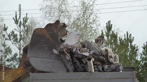 Industrial equipment for loading municipal solid waste into a container for processing and disposal