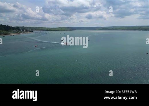 River Camel, Cornwall, England: DRONE VIEWS: The drone flies upstream as a passenger ferry sails from Rock (in b/g) across the river for Padstow. The River Camel rises on the edge of Bodmin Moor and is the second longest river wholly in Cornwall Stock Video Footage - Alamy