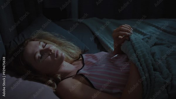 Woman resting peacefully in bed at night