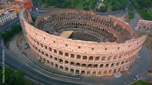 Colosseum, Rome, Italy. Aerial Roman Coliseum on sunrise. Beautiful view of the famous Italian landmark travel icon in the Roman forum.