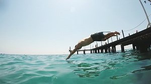 clip-34232071-striking-view-middle-aged-man-diving-head-first