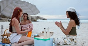 Women friends, beach and sunscreen lotion on vacation with conversation, picnic and umbrella for safety. Girl group, holiday and skincare in sunshine with bottle, product or serum by sea in Cape Town