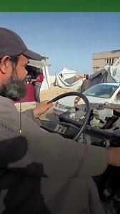 A displaced Palestinian man is roaming the shattered streets of Gaza City in a heavily damaged vehicle he salvaged from under the rubble, turning it into a lifeline for residents struggling to move across the devastated enclave. | The New Arab