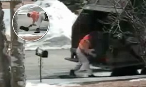 Angry man wrestles mailbox to the ground