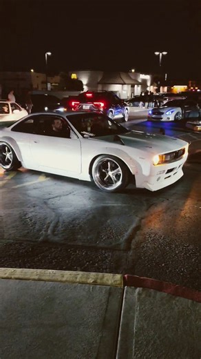 rocket bunny boss s14 nissan 240sx pulls into huge night time car meet