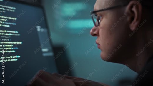 Coding diligently, a bespectacled programmer works at a desktop PC, harnessing artificial intelligence to generate code faster. The workstation buzzes with efficiency, highlighting development tools