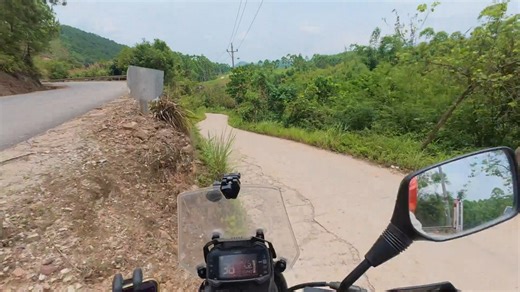 Motorcycle rider crashes on rural cliffside road in Guangxi, China