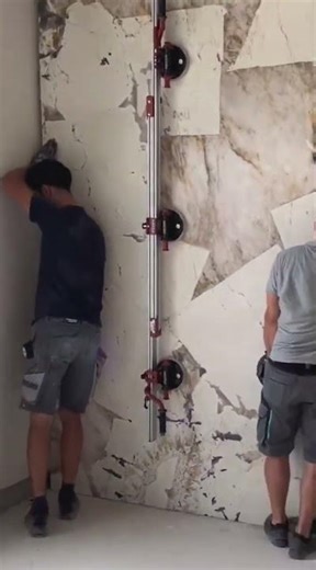 Massive marble slab floats into place, guided by steady hands turning weight into precision artform!