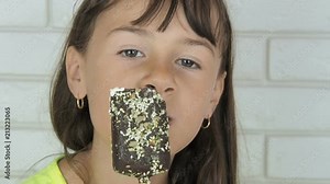 The child eats the ice cream. A little girl is eating ice cream.