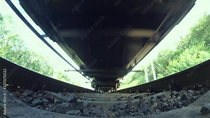 Passing train bottom under view wide angle close-up. Railroad tracks railways train transport system fast speed