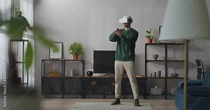 modern technology of virtual reality for home use, man is wearing hmd display for connecting internet and social networking