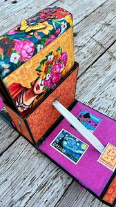 Pop-Up Box Mini Album by @gina.long_c90designs “If you hear a voice within you say ‘You cannot paint,’ then by all means paint, and that voice will be silenced.” -Vincent Van Gogh Hi Friends, Today, I am excited to share my Pop-up Box Mini Album set featuring the Lets Get Artsy collection. I started with Graphic 45 Album in a Box, but instead of using the pages, I created a center box out of chipboard and added some ribbon as the mechanism that lifts the mini album when the box is opened. I cove