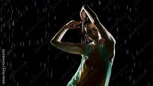 Beautiful woman dancing in the rain. Slow Motion.