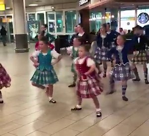 Dancers from the Maryann McCreadie School of Highland Dance welcomed the Paisley 2021 city of culture bid judges as they arrived at Glasgow Airport. | BBC Scotland News