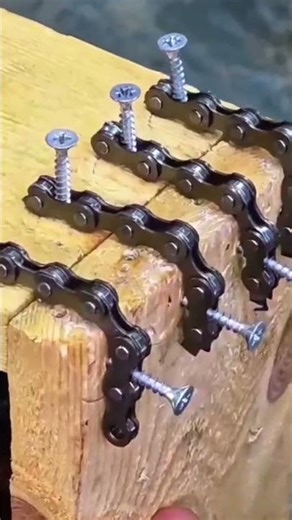 A chain that is being used to connect two wooden boards easily