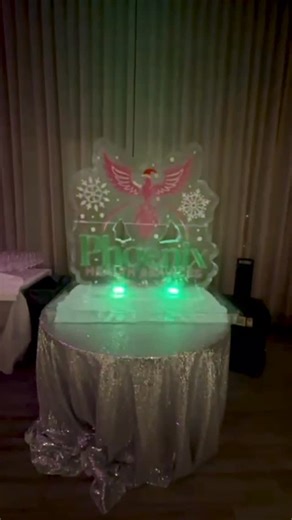 The Ice God on Instagram: "A custom holiday logo ice sculpture created for Phoenix Health Services, celebrating the season with a bold, crystal-clear centerpiece. ❄️🎄🧊🎅 #IceSculpture #LogoIce #HolidayIce #CustomIce #EventDesign #CorporateEvents #HealthcareEvents #PhoenixHealthServices #PHS"