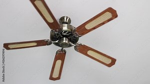 Ceiling fan spinning and rotating pushing down air for ventilation