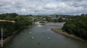 Stoke Gabriel, South Devon, England: DRONE AERIAL VIEWS: The drone flies over boats moored on the River Dart and onwards to the Mill Pond weir with Stoke Gabriel village in the background.