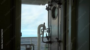 Side pitching. Swell. View through the open door of vessel
