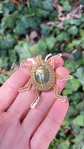 I’ve gotten lots of requests for a beetle pendant, & I finally felt inspired to give it a go! This week’s shop update is insect themed, so it will be in good company among all of the other bug pieces I’ve been working on. 🥰 I chose labaradorite & brass wire for this pendant, & I love how it turned out! • • • #wirewrapping #jewelrymaking #bugjewlery #handmadejewelry #labradoritejewelry #brassjewelry #beetle #bugart | Wicked Wire Crafts