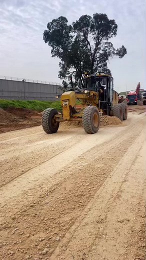 Road Grader Operation on Dirt Road at Construction Site