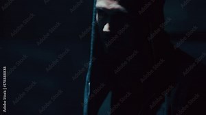 Close up on face of handcuffed man being interrogated & beaten