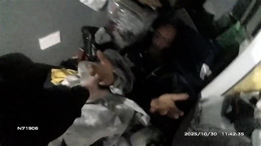 Bizarre moment police find burglar hiding in pile of clothes