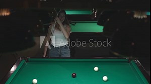 woman plays billiards. a woman hits a billiard ball into a hole. Russian billiards. slow motion video. Record high quality video in Full HD format.