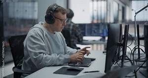 Portrait of a Male Software Developer Working on Computer in a Technological Office, Writing Software Code. IT Programming Department Researching and Developing Commercial Internet Products